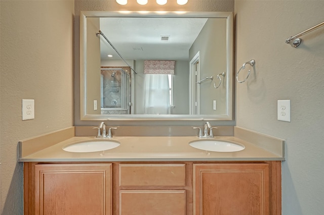 full bathroom featuring double vanity, visible vents, and a sink