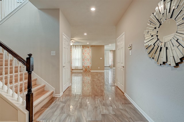 hall featuring stairway, recessed lighting, and baseboards