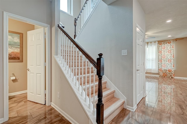 staircase with recessed lighting and baseboards