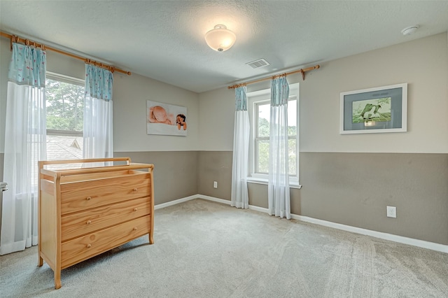 bedroom featuring visible vents, multiple windows, carpet, and baseboards