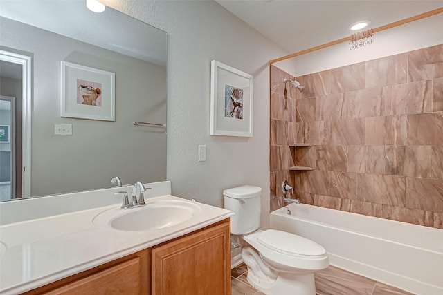 bathroom featuring shower / bathing tub combination, toilet, and vanity