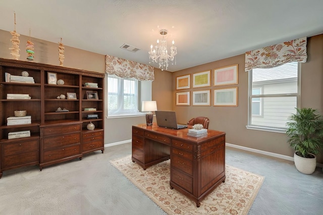 office area with a notable chandelier, baseboards, visible vents, and light carpet