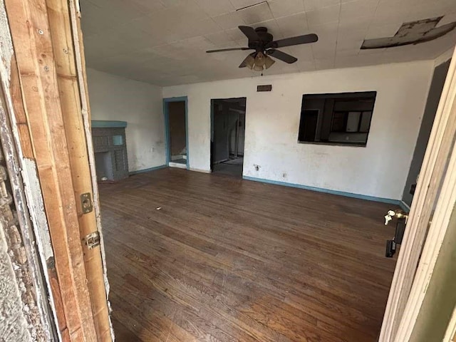 interior space featuring baseboards, ceiling fan, and wood finished floors