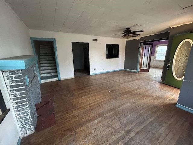 unfurnished living room with visible vents, baseboards, ceiling fan, and wood finished floors