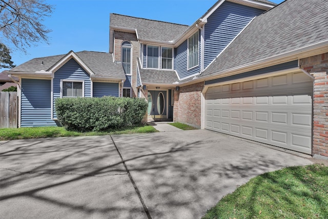 view of front of property with brick siding, a shingled roof, fence, concrete driveway, and a garage