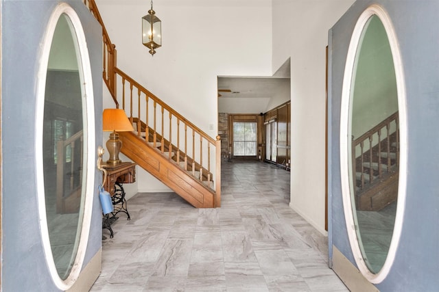 entryway with a high ceiling and stairs