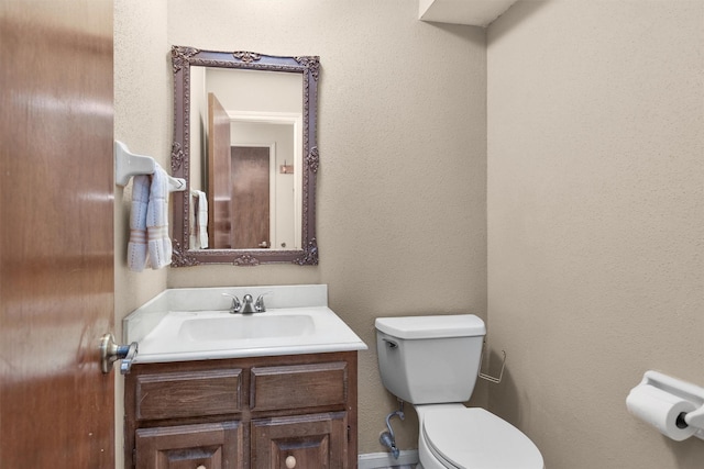 half bath with vanity and toilet