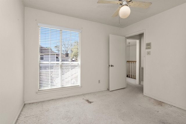 unfurnished bedroom featuring baseboards, carpet floors, and ceiling fan