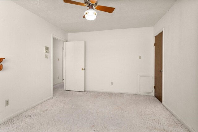 unfurnished bedroom featuring baseboards, carpet, a ceiling fan, and a textured ceiling