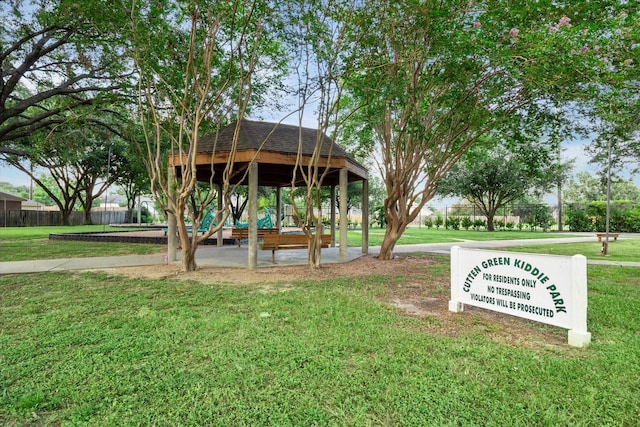 view of community with a gazebo, a yard, and fence