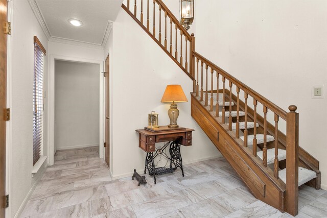 stairs with baseboards, marble finish floor, and crown molding