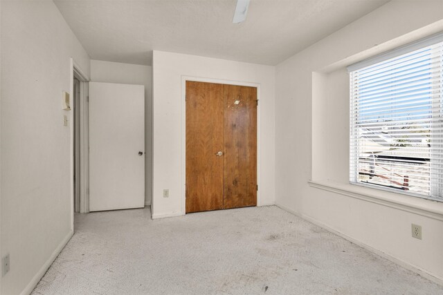 unfurnished bedroom featuring ceiling fan, baseboards, and carpet floors