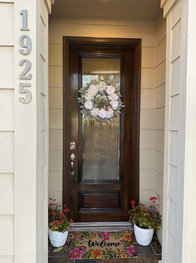 doorway to property featuring concrete block siding