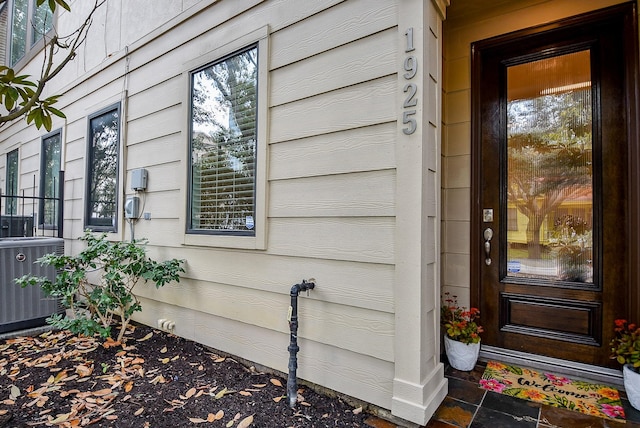 doorway to property featuring central air condition unit