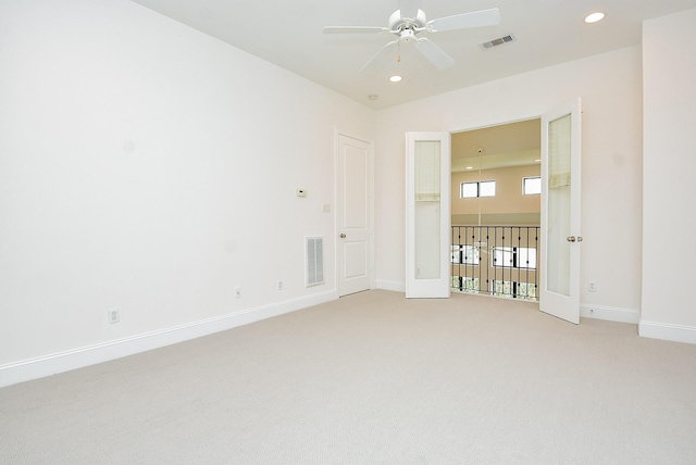 empty room featuring a ceiling fan, recessed lighting, light colored carpet, and visible vents