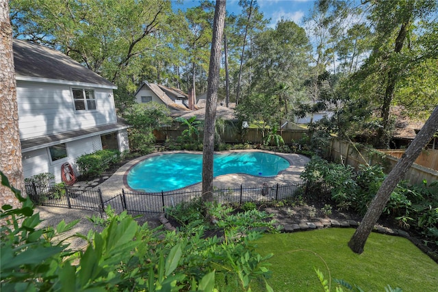 view of pool with a fenced in pool, a lawn, and a fenced backyard