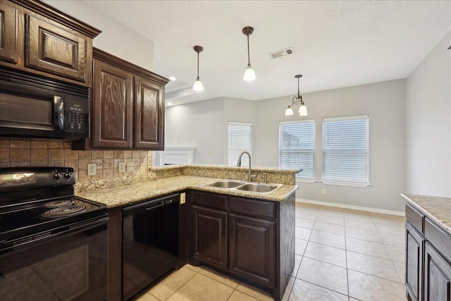 kitchen featuring visible vents, a sink, decorative backsplash, black appliances, and dark brown cabinetry