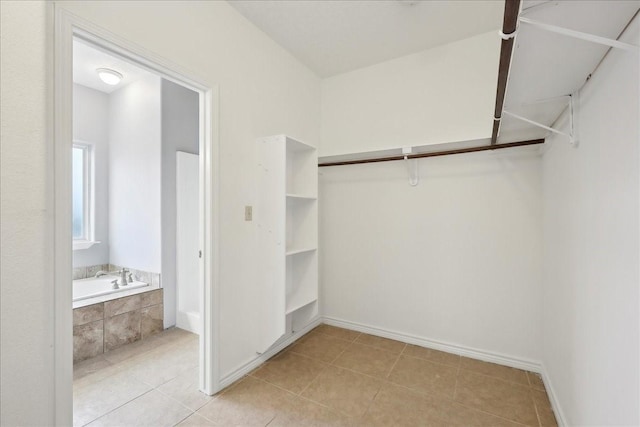 spacious closet featuring light tile patterned flooring