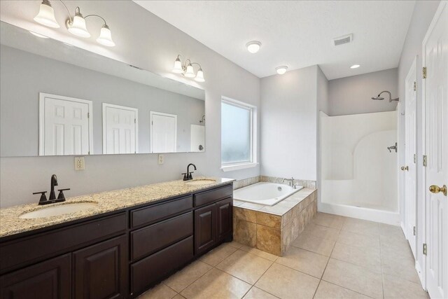 bathroom featuring tile patterned flooring, a bath, a shower, and a sink