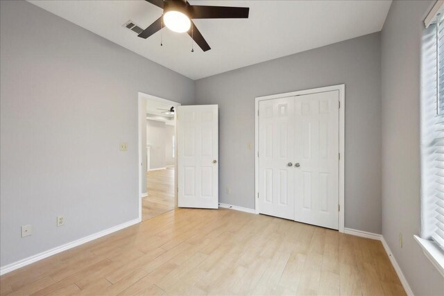 unfurnished bedroom with visible vents, baseboards, light wood-style floors, a closet, and a ceiling fan