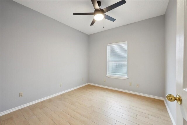 unfurnished room with baseboards, light wood-style floors, and a ceiling fan