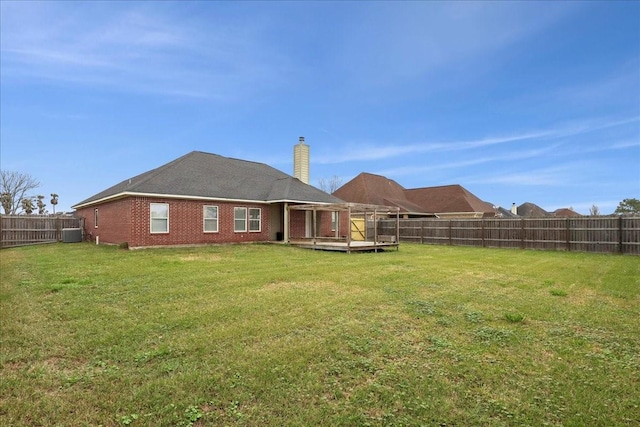 view of yard featuring a deck, central air condition unit, and a fenced backyard