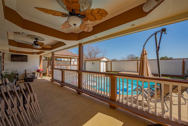 view of swimming pool featuring a patio, a fenced in pool, a shed, a fenced backyard, and an outdoor structure