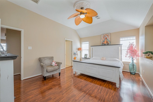 bedroom featuring visible vents, multiple windows, dark wood-style floors, and vaulted ceiling