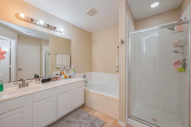 bathroom with vanity, visible vents, tile patterned flooring, a shower stall, and a garden tub