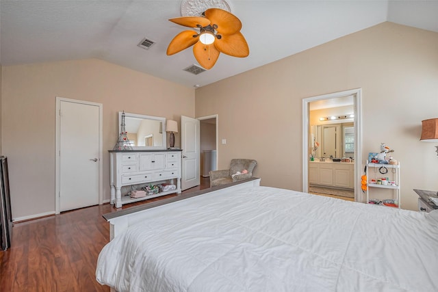 bedroom with visible vents, ceiling fan, vaulted ceiling, wood finished floors, and ensuite bath