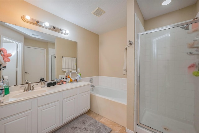 bathroom featuring tile patterned floors, visible vents, a stall shower, and a bath