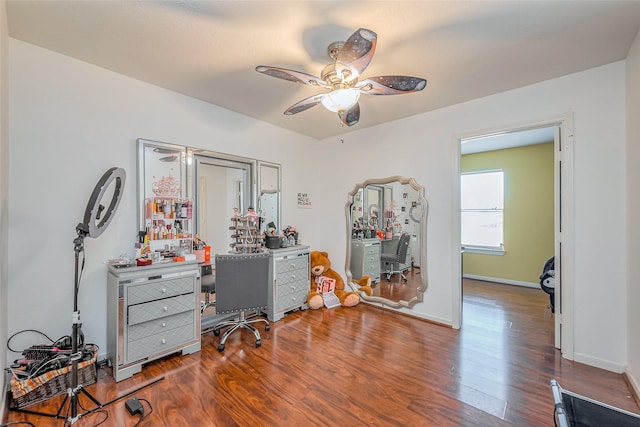 office area with ceiling fan, baseboards, and wood finished floors