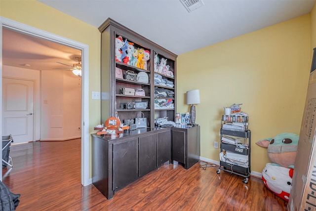 office space featuring visible vents, baseboards, a ceiling fan, and wood finished floors