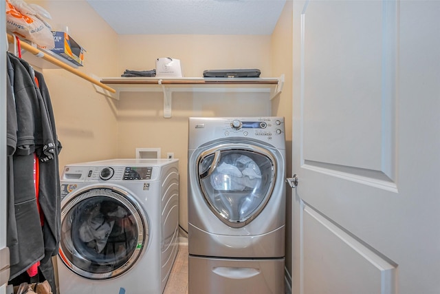 washroom featuring washing machine and dryer and laundry area