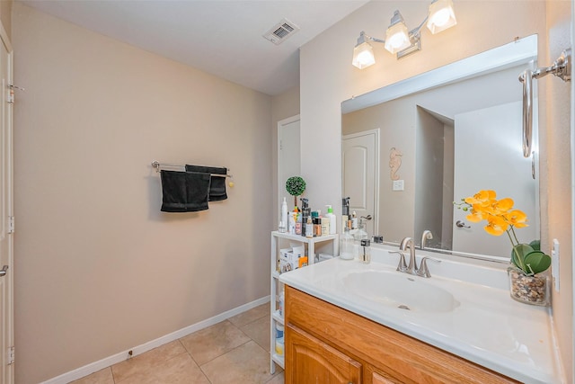 bathroom featuring tile patterned floors, visible vents, baseboards, and vanity