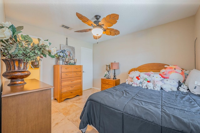 bedroom with visible vents, baseboards, ceiling fan, and light tile patterned flooring