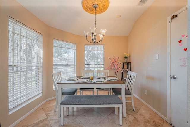 dining area with visible vents, a notable chandelier, light tile patterned flooring, baseboards, and vaulted ceiling