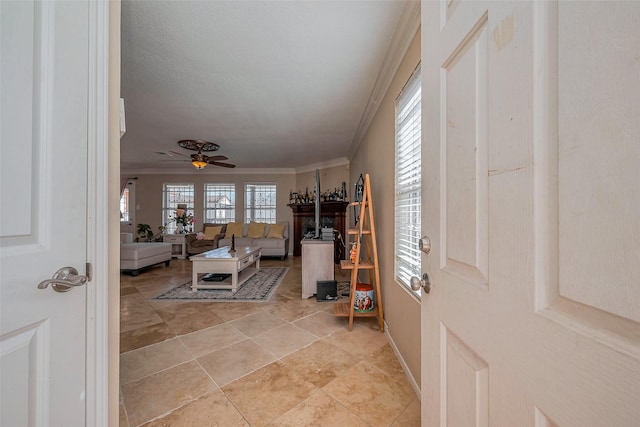 foyer featuring crown molding and ceiling fan