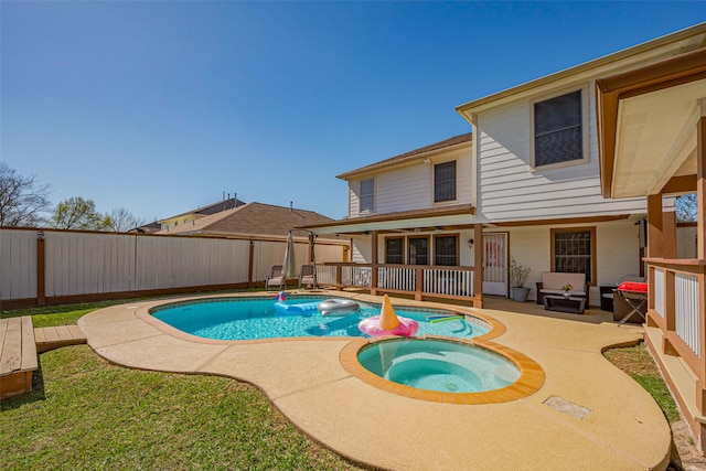 view of pool with a patio area, a fenced backyard, and a pool with connected hot tub