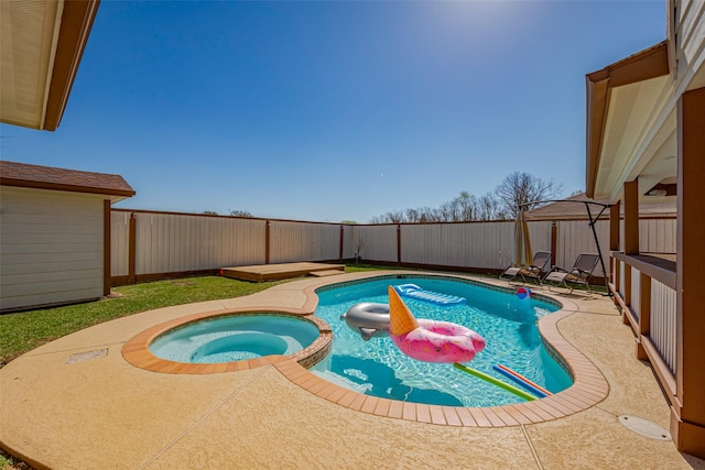 view of pool with a patio, a fenced backyard, and a pool with connected hot tub