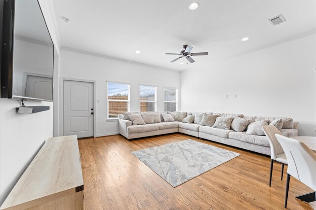 living room with visible vents, recessed lighting, wood finished floors, and ornamental molding