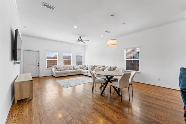 dining room with visible vents, baseboards, recessed lighting, ceiling fan with notable chandelier, and wood finished floors