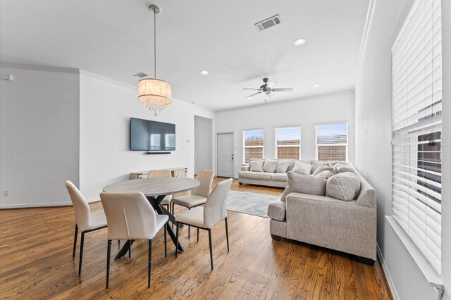 dining room with visible vents, crown molding, baseboards, recessed lighting, and wood finished floors