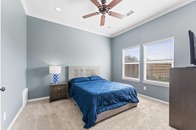 carpeted bedroom with crown molding, baseboards, visible vents, and ceiling fan