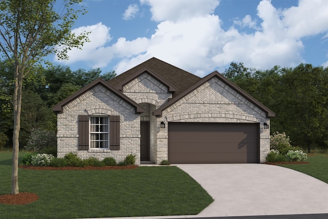 french provincial home with brick siding, an attached garage, driveway, and a front yard