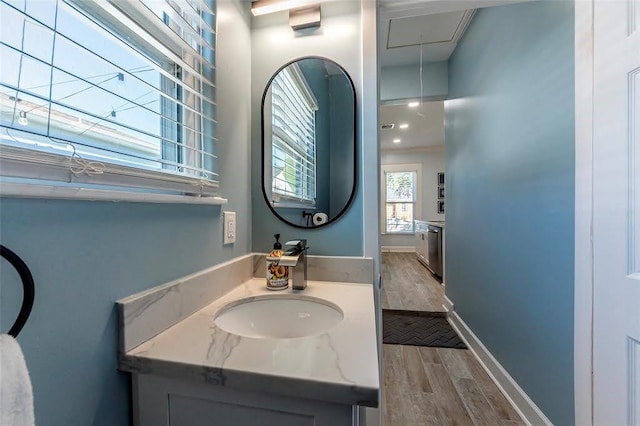 bathroom featuring vanity, wood finished floors, and baseboards