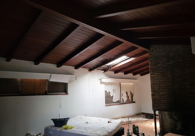 bedroom featuring wooden ceiling and vaulted ceiling with beams