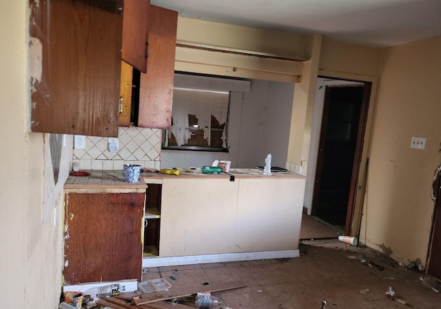 kitchen with backsplash and tile countertops