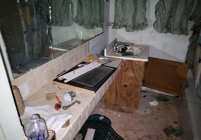 bathroom with decorative backsplash and a sink