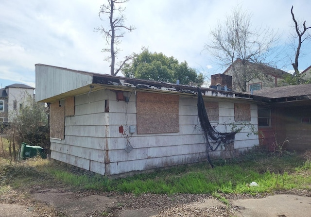 view of side of home with a chimney